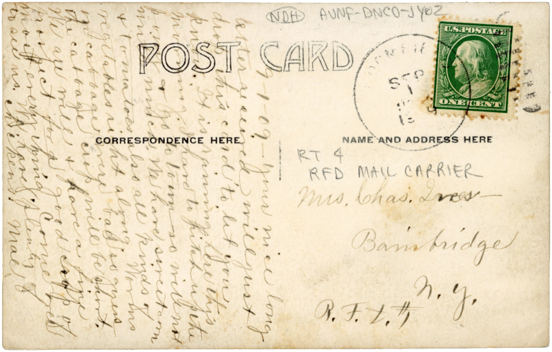 R.F.D. Route 4 mail wagon at a farmhouse, Bloomfield, Nebraska — “C.S. Lovejoy. R 4. Bloomfield Neb” in the negative (back)