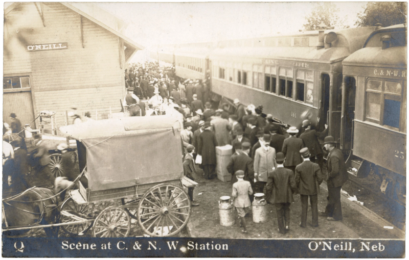 Crowd at the Chicago & North Western station, O'Neill, Nebraska — T. E. Halldorson Co.